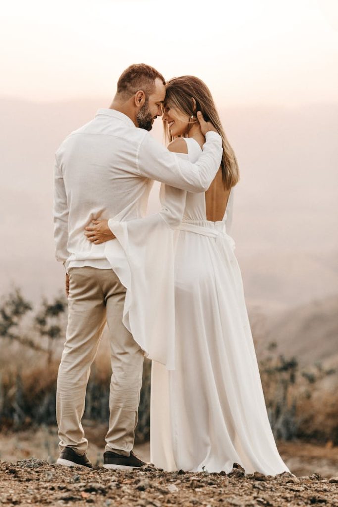 A bride and groom embracing in a serene outdoor setting, symbolizing love and unity.